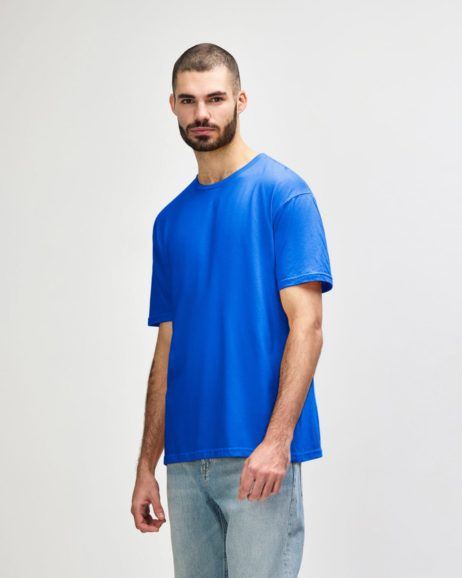 A blue Gildan Softstyle adult T-shirt displayed on a model, featuring a basic crew neck design and short sleeves.