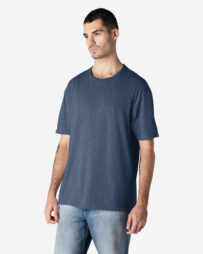 A navy adult T-shirt displayed on a male model, featuring a crew neck and short sleeves. The shirt has a logo.
