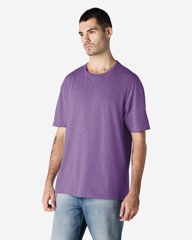 A purple Gildan Softstyle adult T-shirt displayed on a male model, featuring a relaxed fit and basic design.