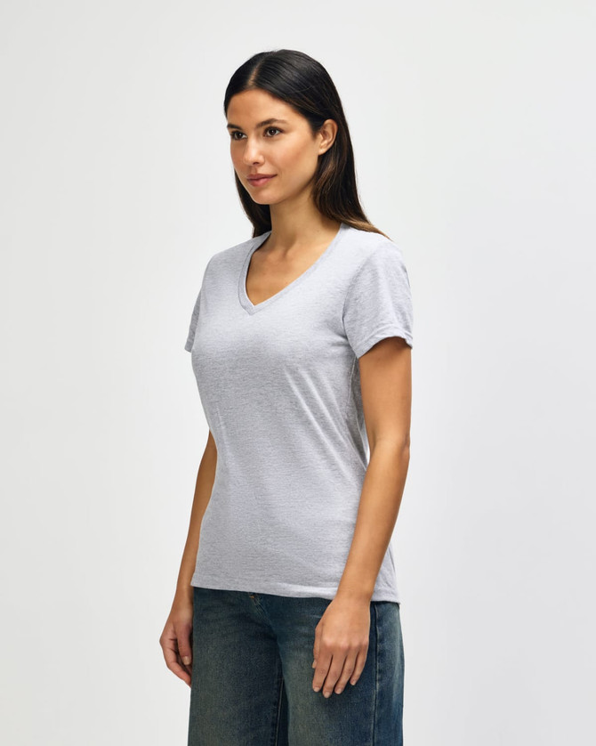 A grey Gildan Softstyle ladies' V-neck T-shirt displayed on a model, featuring short sleeves and a relaxed fit.