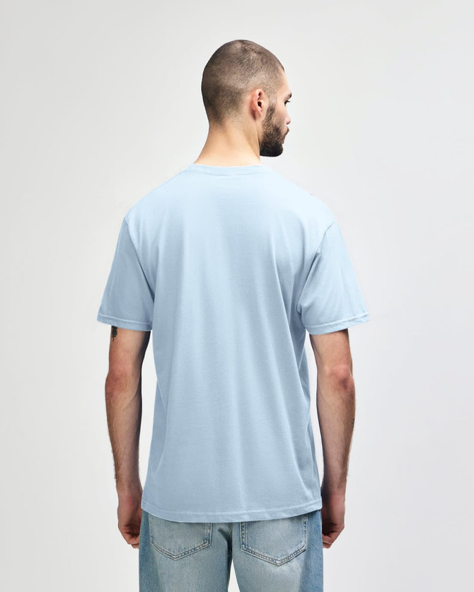 A person wearing a blue Gildan Softstyle adult midweight T-shirt, viewed from the back. The shirt has a logo.