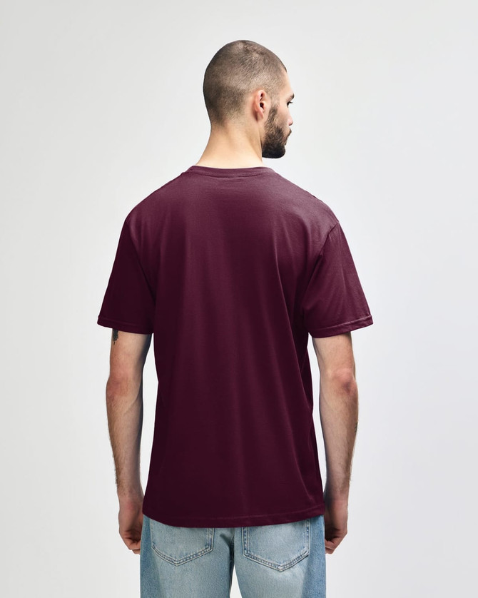 A person wearing a maroon Gildan Softstyle Adult Midweight T-Shirt, viewed from the back. The shirt has no visible logos.