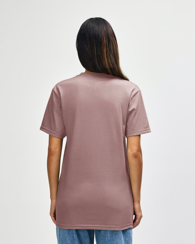A midweight t-shirt in a muted pink shade, featuring a plain back and short sleeves. It has a branding logo.