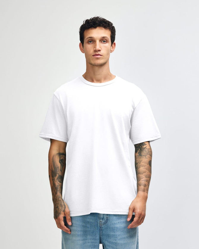 A white unisex short sleeve t-shirt displayed on a model, featuring a simple design and casual fit.