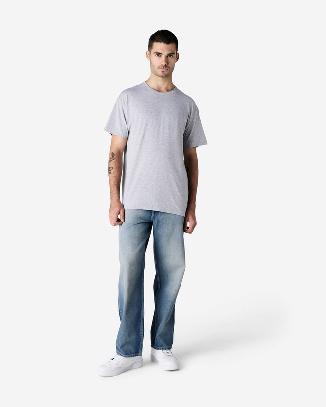 A light grey Gildan cotton t-shirt worn with light blue jeans, displayed on a male model.