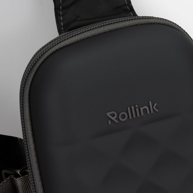 A black, textured bag with a padded surface and a strap, featuring a small logo.