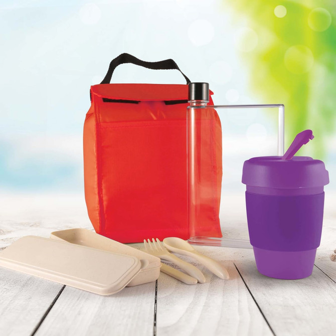 A red picnic bag with a drink bottle, purple cup, utensils, and a clear container.