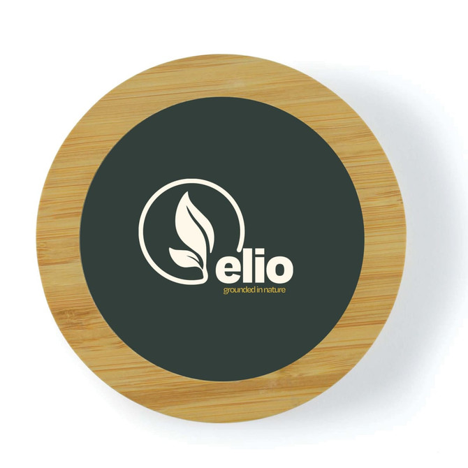 A circular bamboo wireless charger with a dark surface featuring a logo. The edge is made of light bamboo wood.