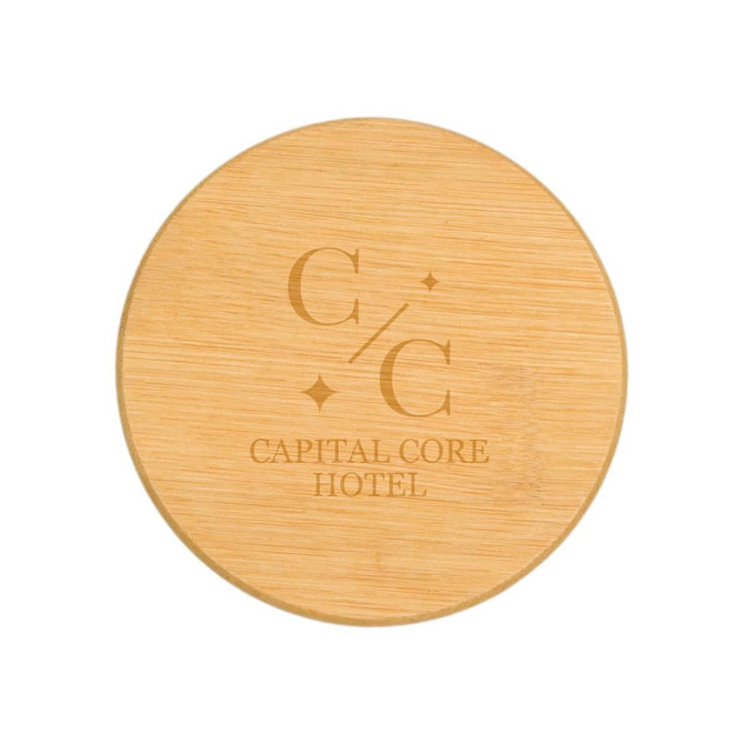 A round bamboo coaster featuring a logo and text for "Capital Core Hotel". The surface is smooth and natural in texture.