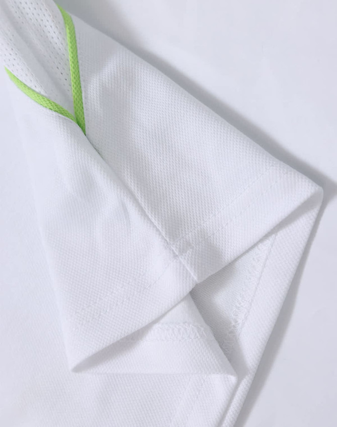 A white polo shirt with a green accent, featuring short sleeves and a textured fabric. It includes a logo.