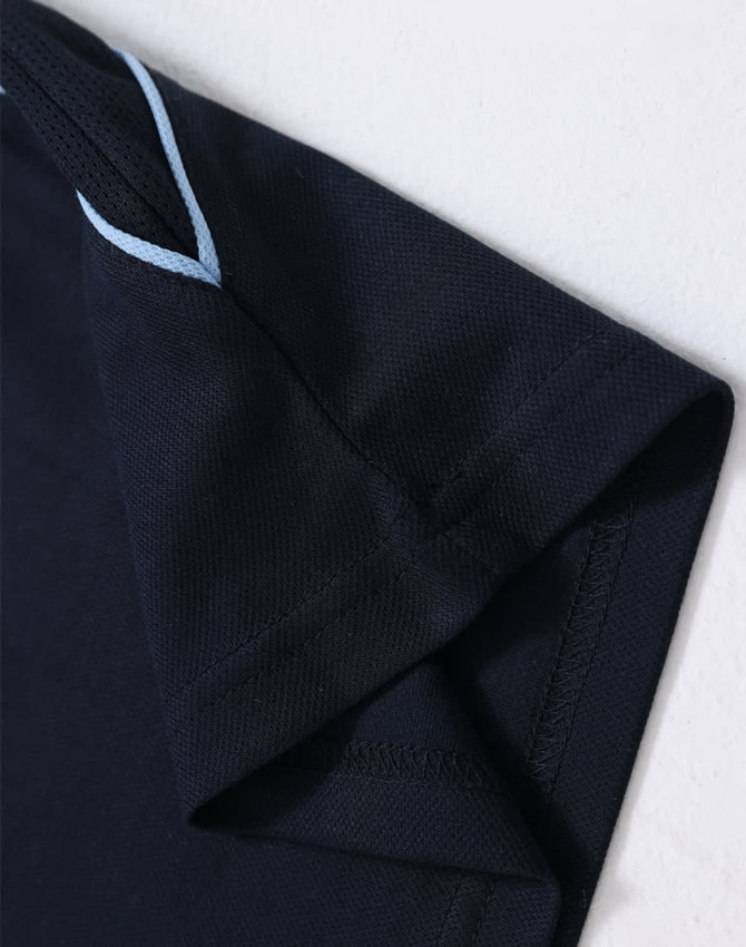 A navy polo shirt featuring a contrasting light blue trim on the collar and sleeves, with a logo present.