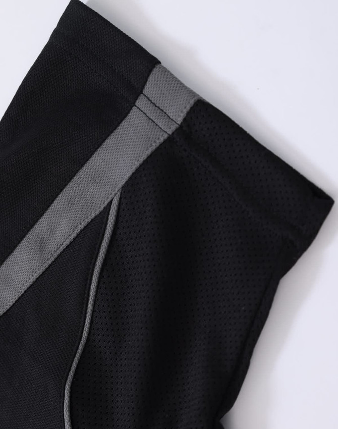 A black polo shirt featuring a grey trim along the shoulder seams and has a branding logo.