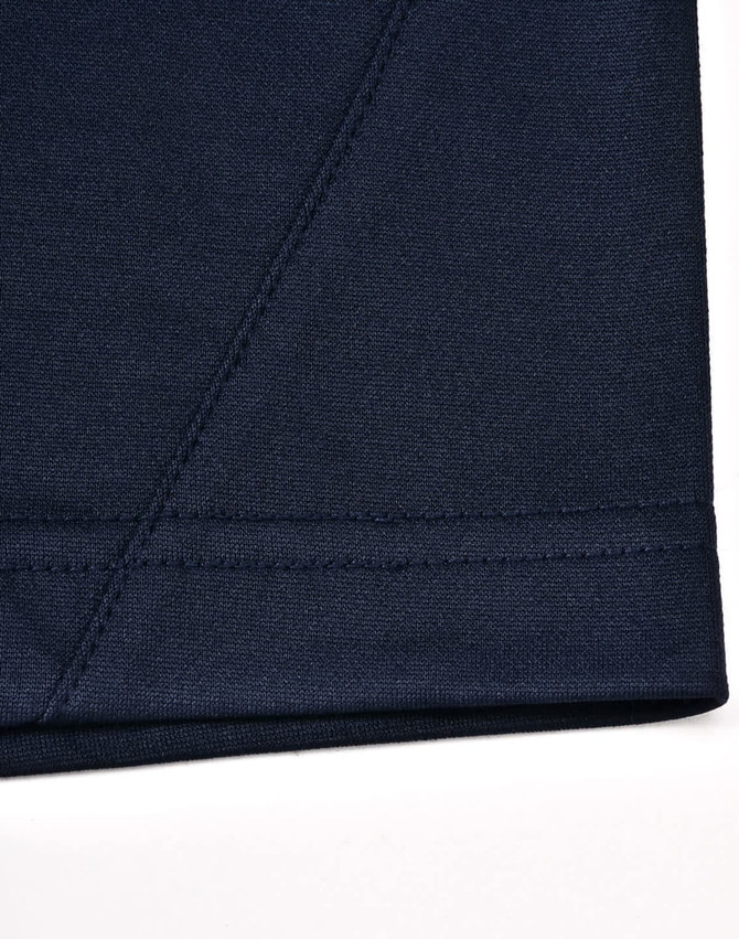 A close-up of a navy blue polo shirt featuring contrast stitching and a logo.