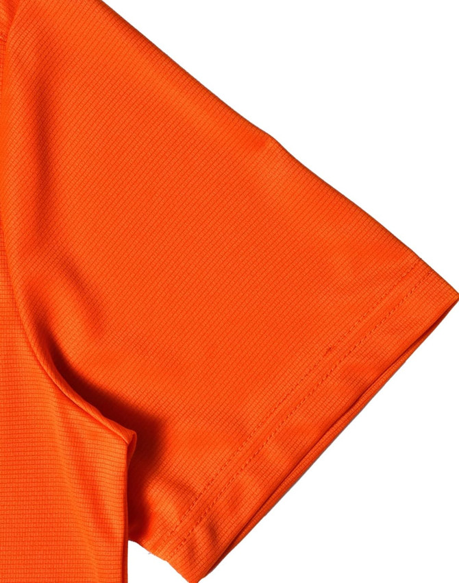 An orange short-sleeved performance t-shirt with a textured fabric and a logo on the design.