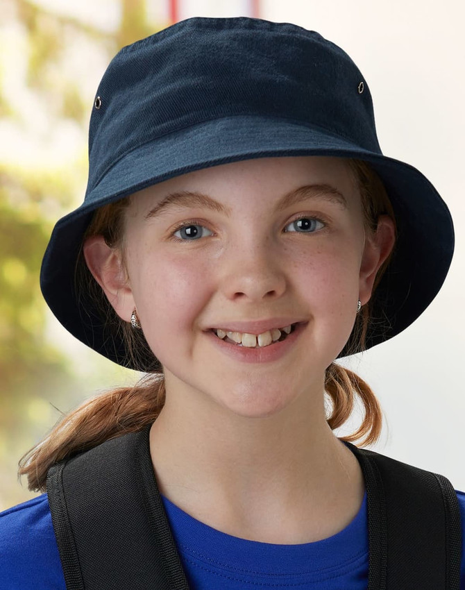 A navy soft washed bucket hat featuring eyelets, worn by a smiling child with a ponytail.