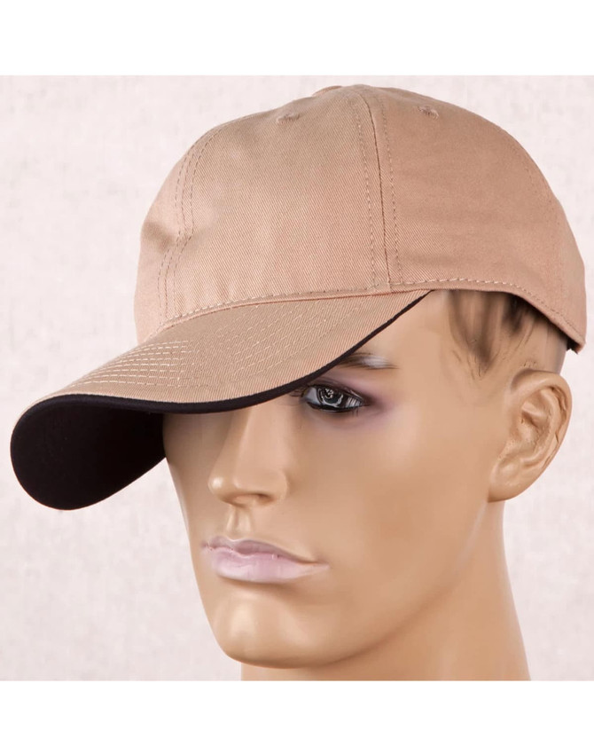 A tan cap with a contrasting dark peak, displayed on a mannequin head. The cap features a logo on the side.