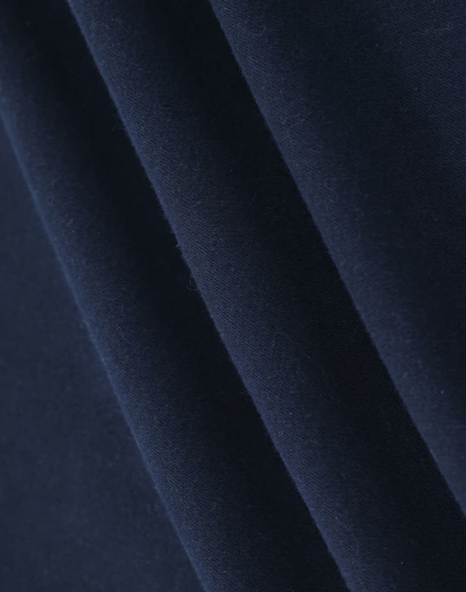 A close-up of soft, dark navy fabric, highlighting its smooth texture and folds.