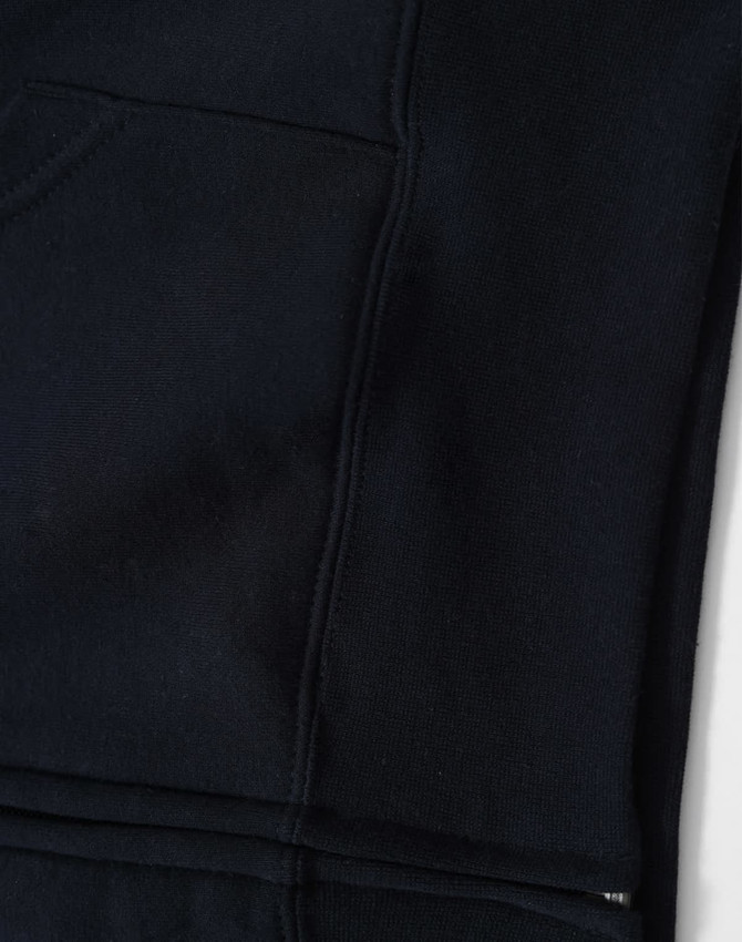 A black full-zip fleecy hoodie featuring a front pocket and a smooth texture. It has a logo on the fabric.