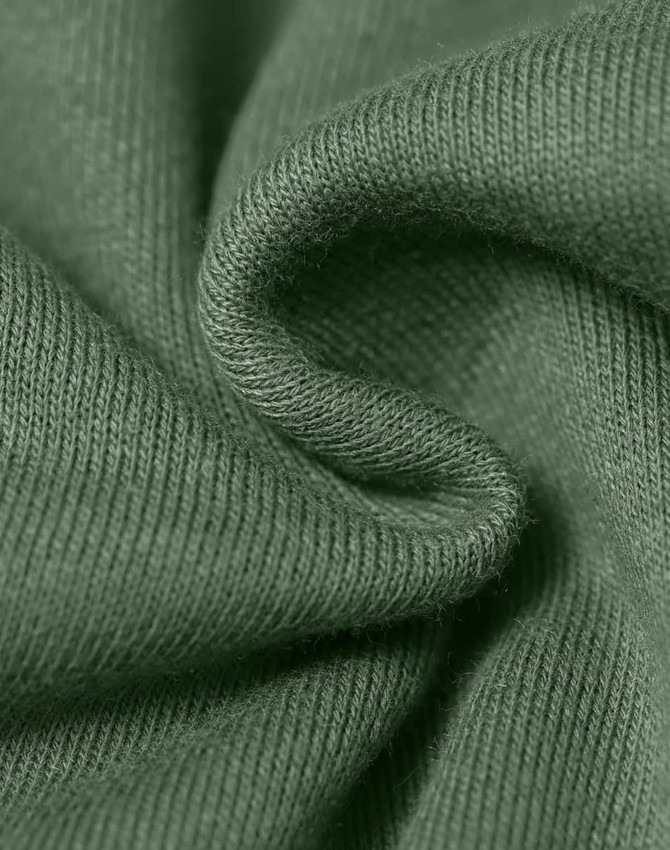 A close-up of textured fabric in a muted green colour, highlighting its soft and snug qualities.