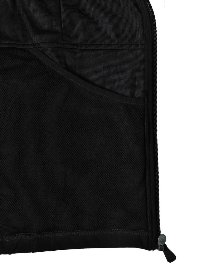 A close-up of the interior of a black softshell jacket, featuring a mesh pocket and zipper detail.