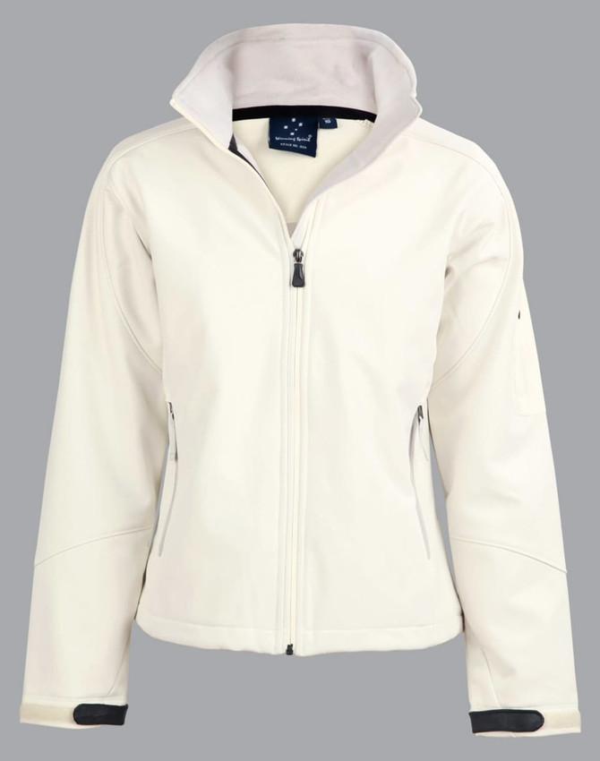 A softshell jacket in cream with a zip front, featuring two side pockets and a logo on the chest.