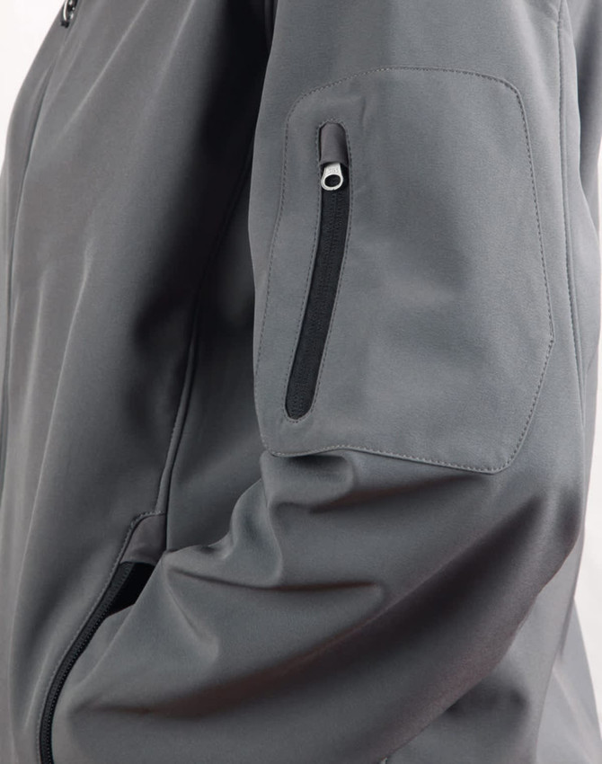 A grey softshell jacket featuring a zippered pocket on the sleeve and a sleek design.