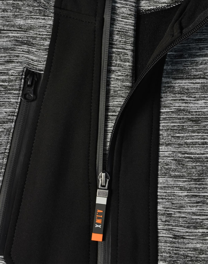 A grey and black jacket featuring a zippered front and a logo on the zipper pull.