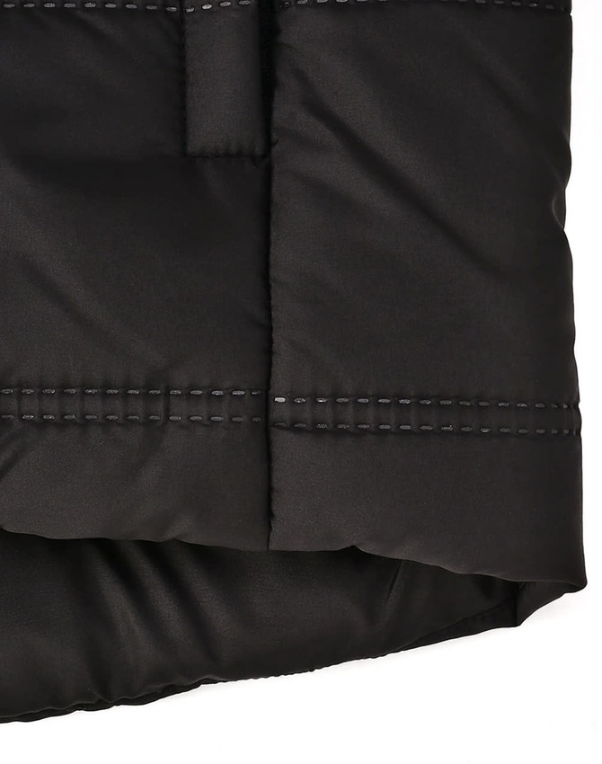 A black sustainable seamless parka jacket featuring a 3D cut with visible stitching details. It has a logo.