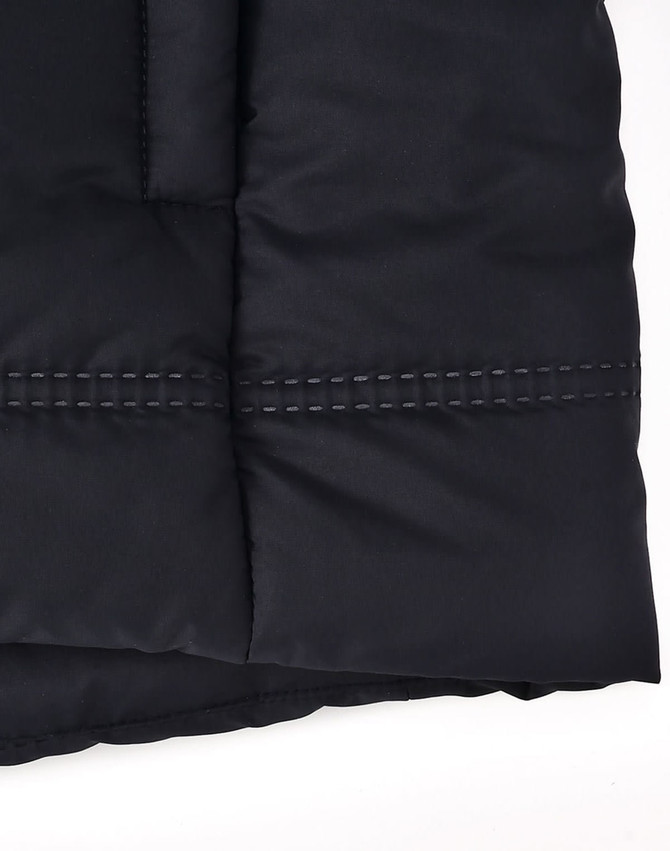 A close-up of a black seamless parka jacket, featuring a textured fabric and contrasting stitching details.