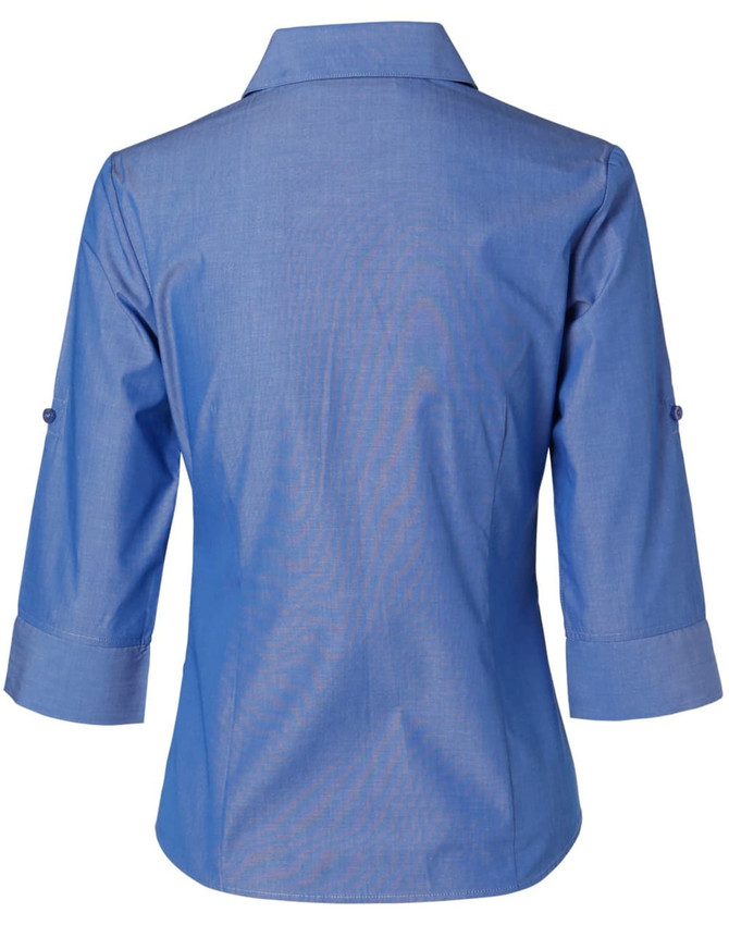 A blue women's button-up shirt with 3/4 sleeves, featuring a collar and rolled-up cuffs. The shirt has a logo.