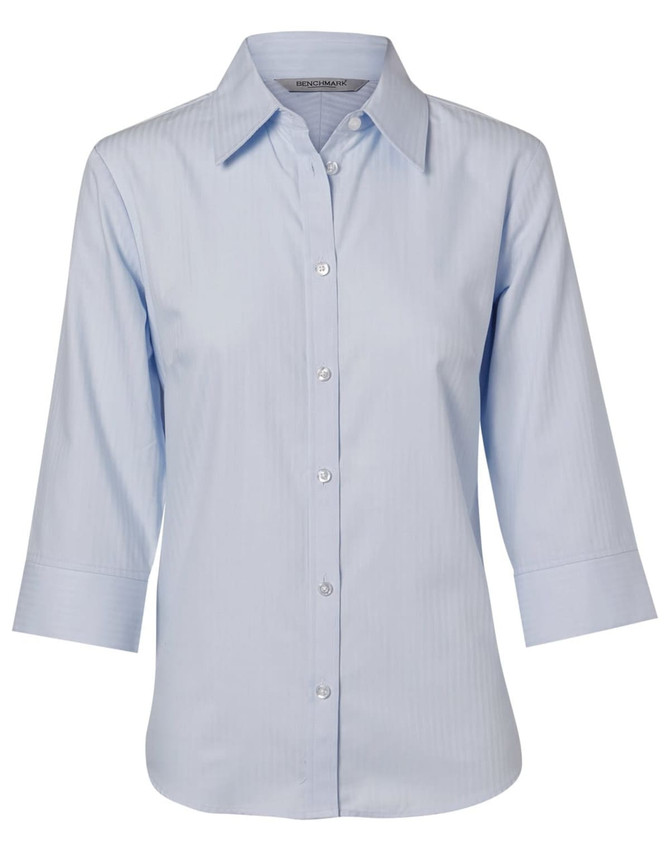 A light blue women's button-up shirt with 3/4 sleeves and a herringbone pattern, featuring a logo on the label.