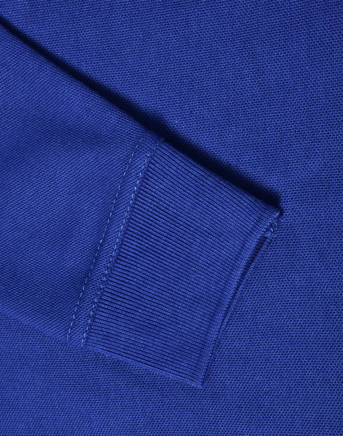 A close-up of a blue long sleeve polo shirt, showcasing the knit texture and ribbed cuff detail.