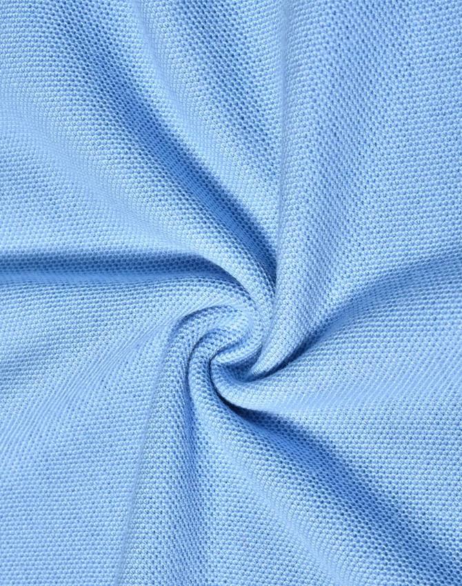 A close-up view of light blue poly/cotton pique knit fabric with a textured weave, showcasing its softness and drape.