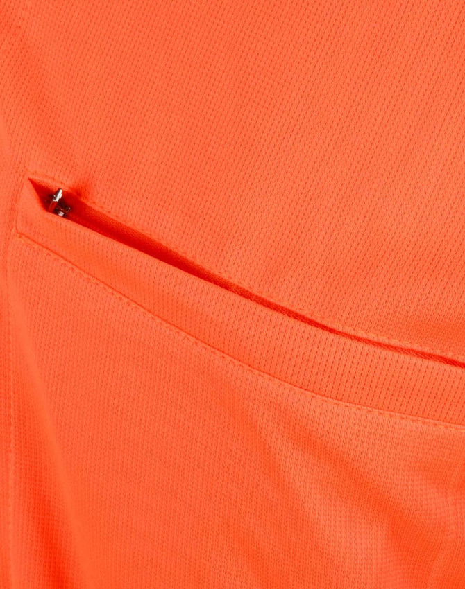An orange polo shirt featuring a vented pocket, showcasing a breathable fabric texture.