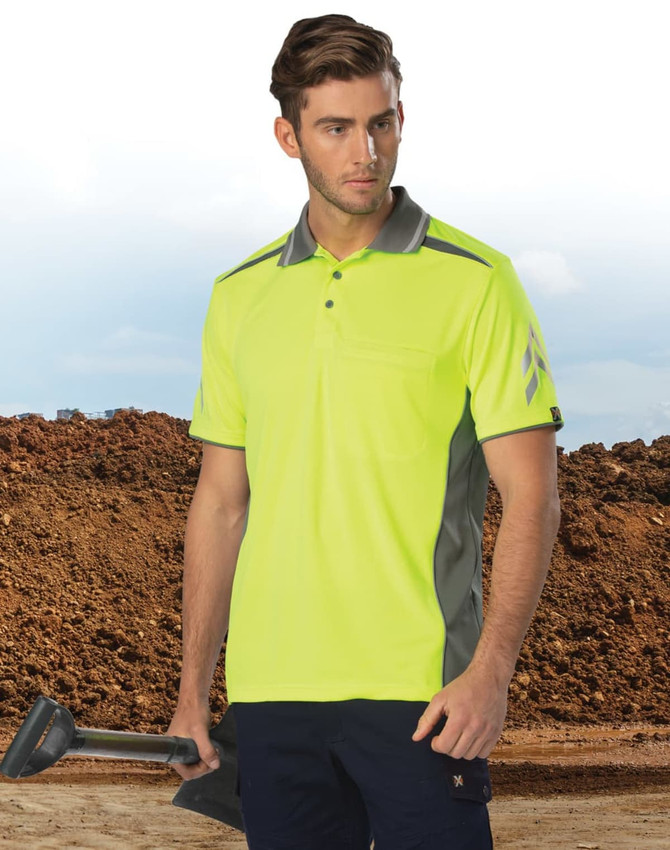 A bright yellow and grey vented polo shirt with a pocket, displayed on a model against a construction backdrop.