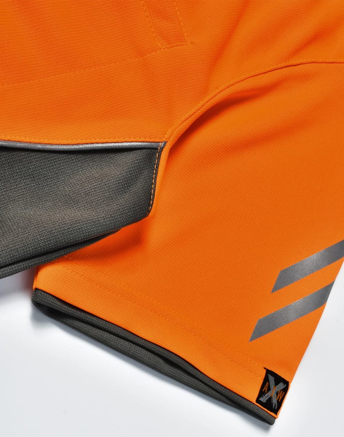 An orange polo shirt featuring grey accents and a logo on the hem.