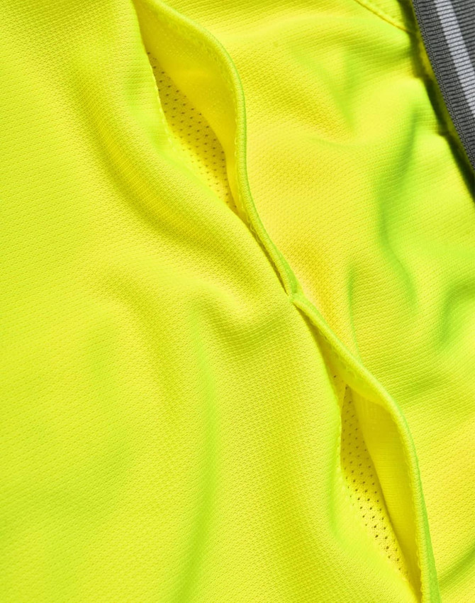 A close-up of a bright yellow vented fabric from a polo shirt, featuring a grey stripe. The material has a textured appearance.