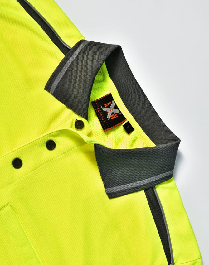 A bright yellow polo shirt featuring a grey collar and stripe detailing, with a branding label visible.