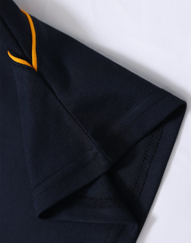 A navy polo shirt with orange detailing at the collar and sleeve. Features a logo on the fabric.