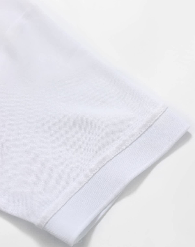 A white polo shirt featuring a smooth sleeve cuff, designed with a logo on the fabric.