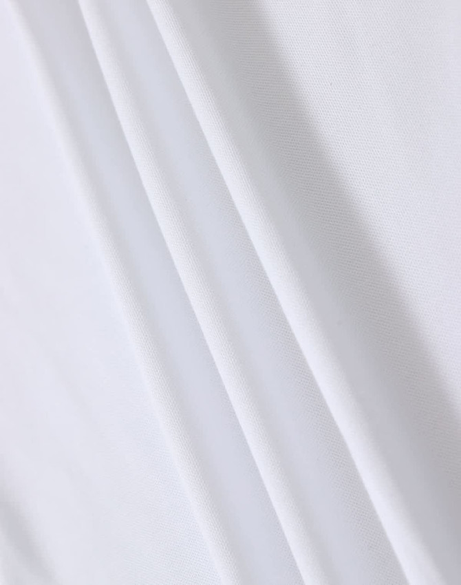 A white fabric featuring smooth folds, suitable for a polo shirt. The material appears lightweight with a subtle texture.