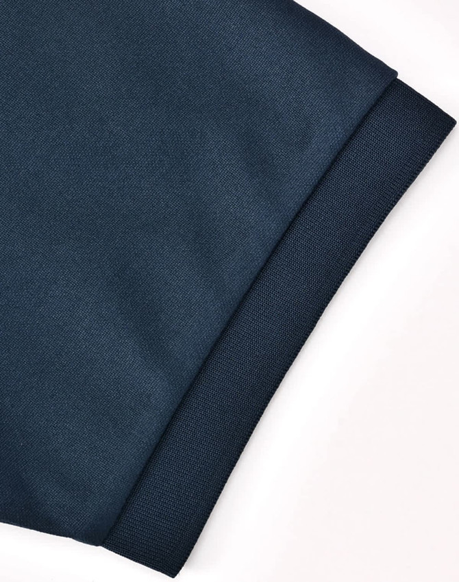A close-up of a dark blue polo shirt sleeve featuring a textured finish and a logo.