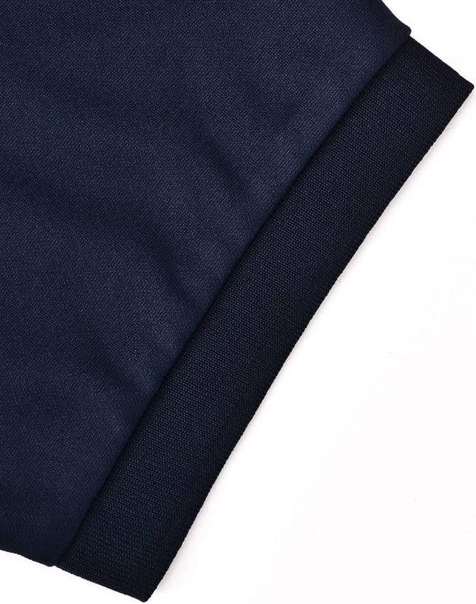 A close-up of a navy blue polo shirt sleeve featuring a textured knit cuff and a logo.