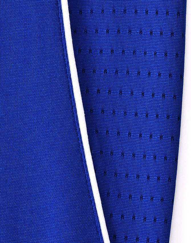 A close-up of a blue polo shirt featuring contrasting fabric textures and a white trim. It has a logo on the garment.