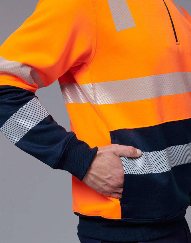 An orange and navy work jumper featuring reflective stripes and a front pocket. Includes a partial zip at the collar.