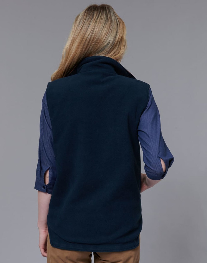 A navy reversible safety vest with a snug collar, shown from the back, paired with a blue shirt underneath.