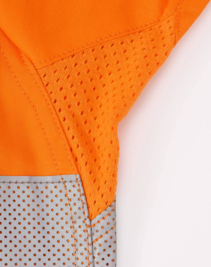 An orange long-sleeve shirt featuring perforated silver tape detailing. The shirt has a logo.