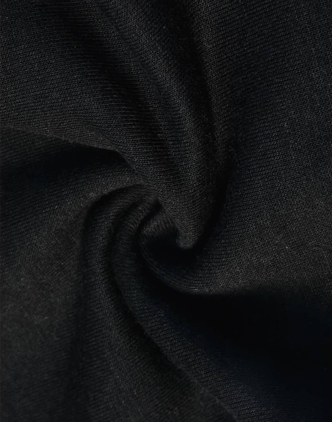 A close-up of black poly/cotton fabric, featuring a soft and smooth texture suitable for sweat pants.