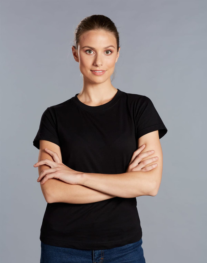 A black cotton semi-fitted tee on a model with arms crossed, against a grey background. The shirt has a logo.