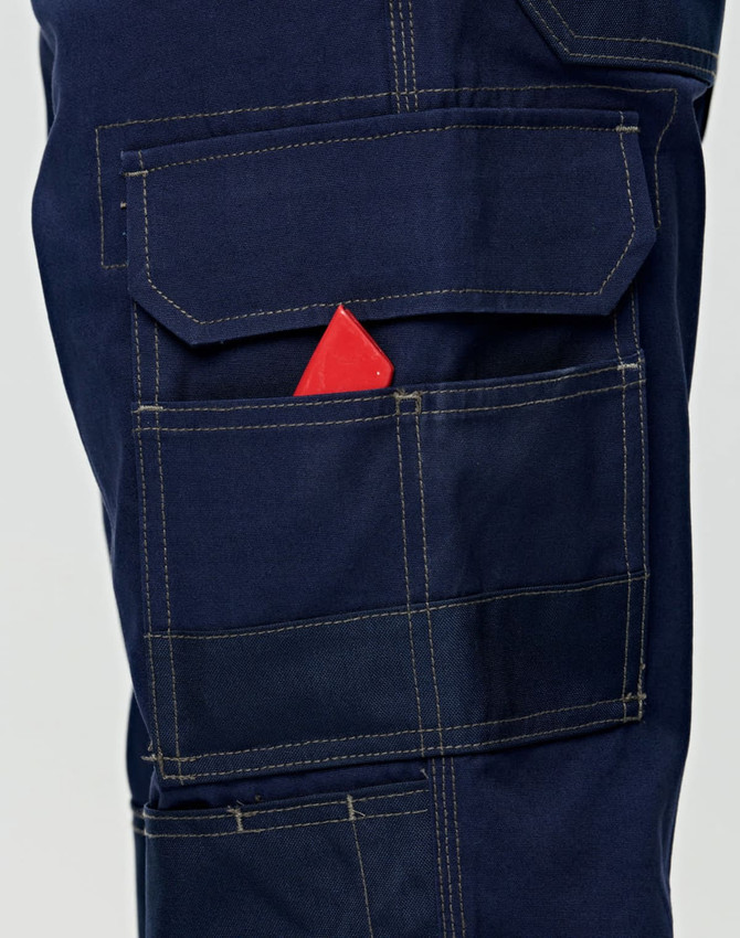 Navy blue semi-fitted Cordura work pants featuring multiple pockets, including a visible pocket with a red item.